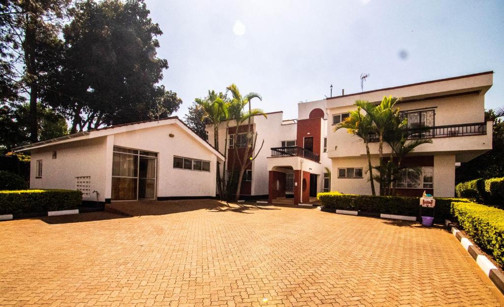 a house with a brick driveway in front of it at Bonsai Village in Nairobi