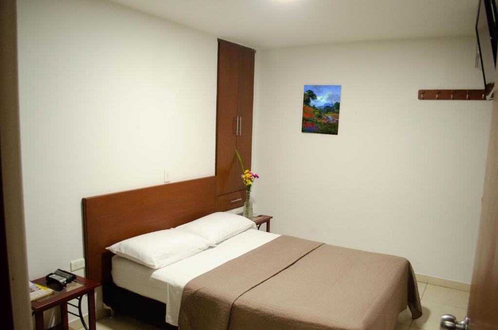 Postel nebo postele na pokoji v ubytování Hotel El Faro Buga