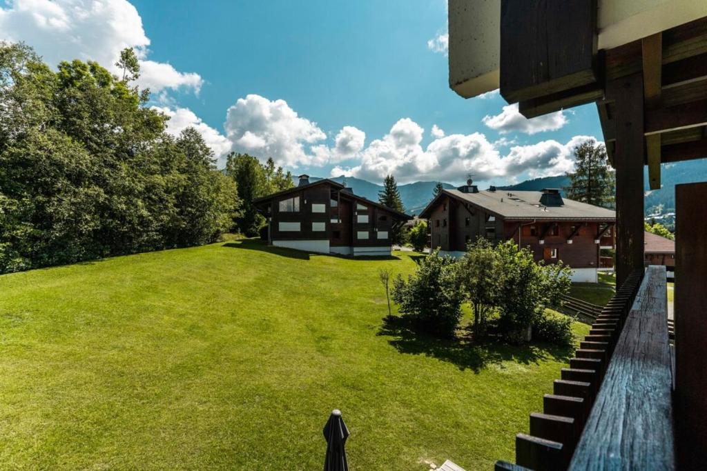 an aerial view of a yard with a house at Studio with balcony and views of the golf course and surrounding mountains in Megève