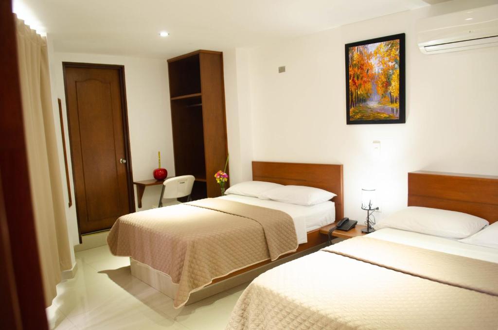 Postel nebo postele na pokoji v ubytování Hotel El Faro Buga