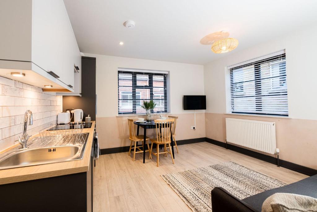 a kitchen with a sink and a table at 1 Castle Mews in Salisbury