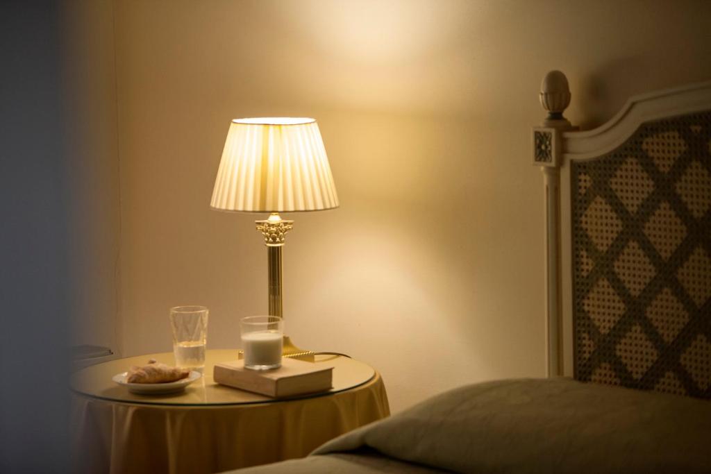 Postel nebo postele na pokoji v ubytování Hotel Villa Giona