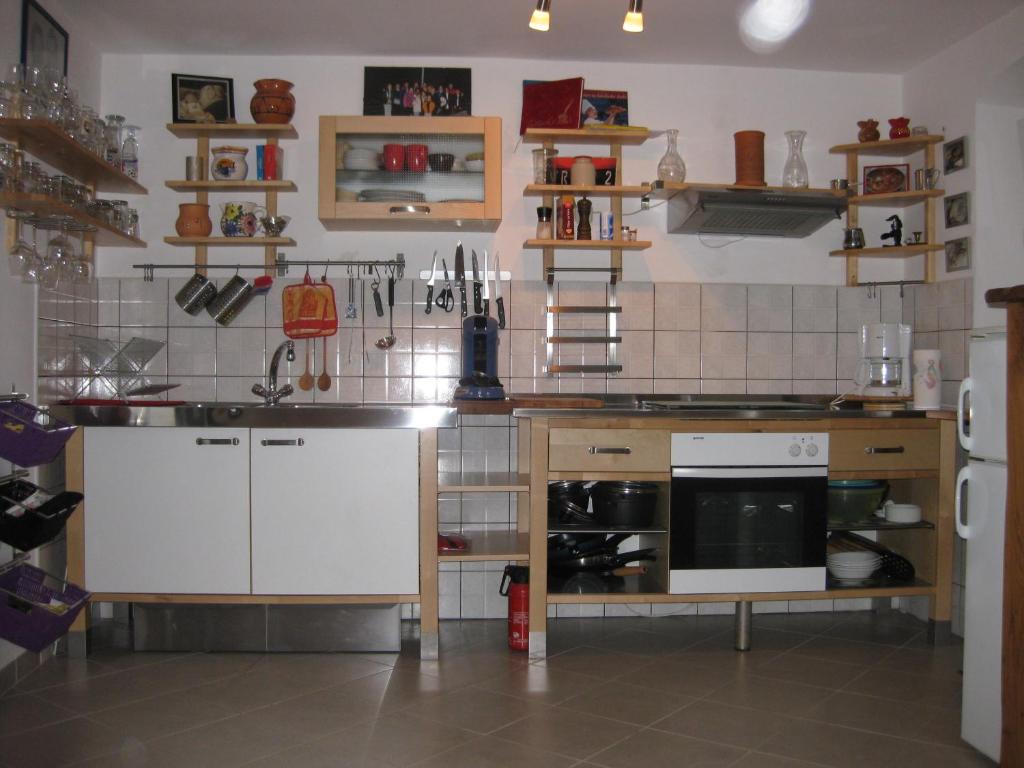 a kitchen with white cabinets and a stove top oven at Apartment Roby in Vrsar