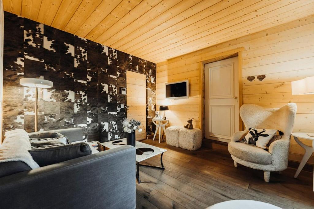 a living room with a couch and a chair at Cozy apartment near the city center in Megève