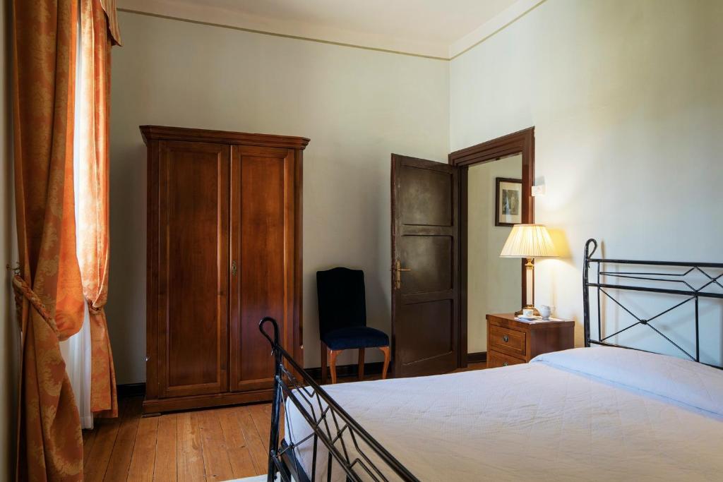Postel nebo postele na pokoji v ubytování Hotel Villa Giona