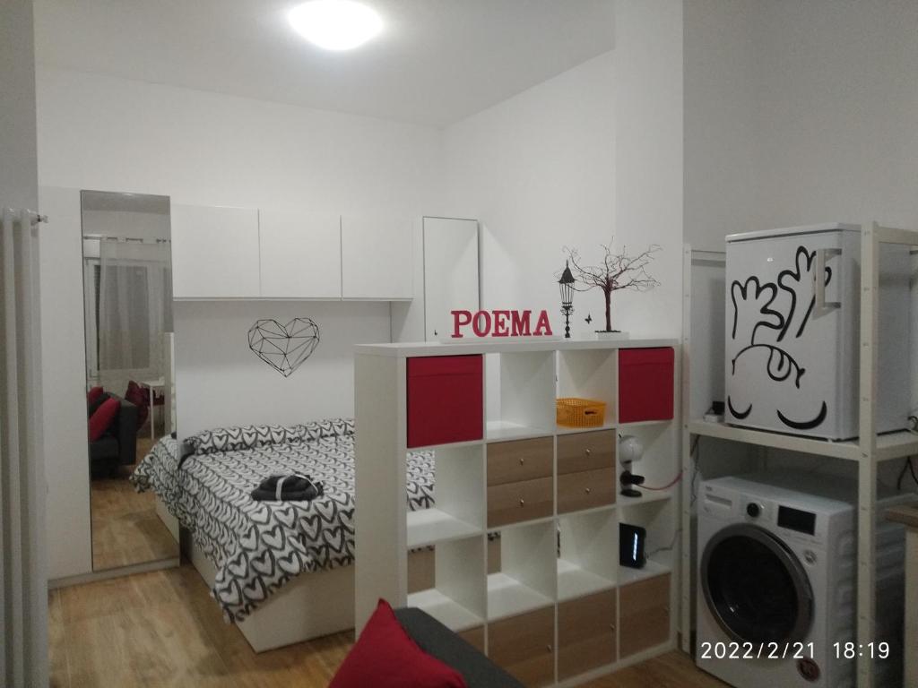 a room with a bedroom with a bed and a microwave at Poema Apartment in Casalecchio di Reno