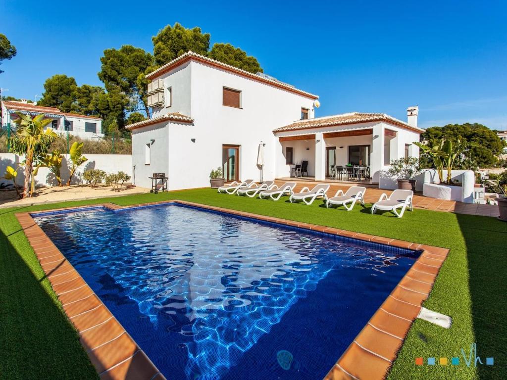 a villa with a swimming pool in front of a house at VH CostaBlanca - PINETS in Benissa
