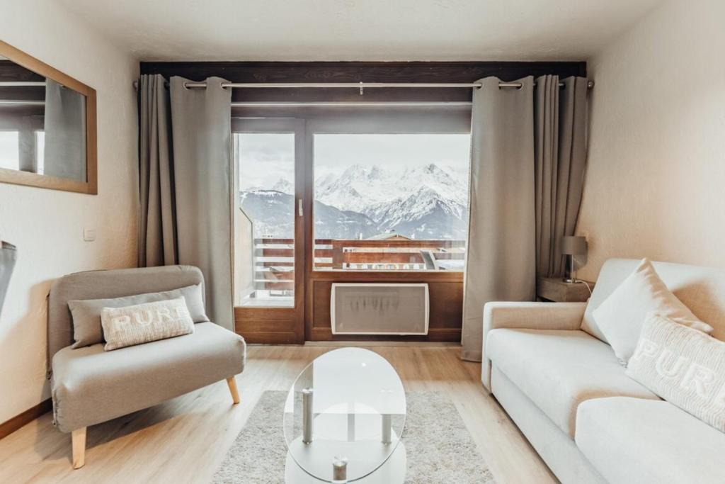 a living room with a view of a mountain at Furnished studio on the ski slopes with a terrace & panoramic views in Saint-Gervais-les-Bains