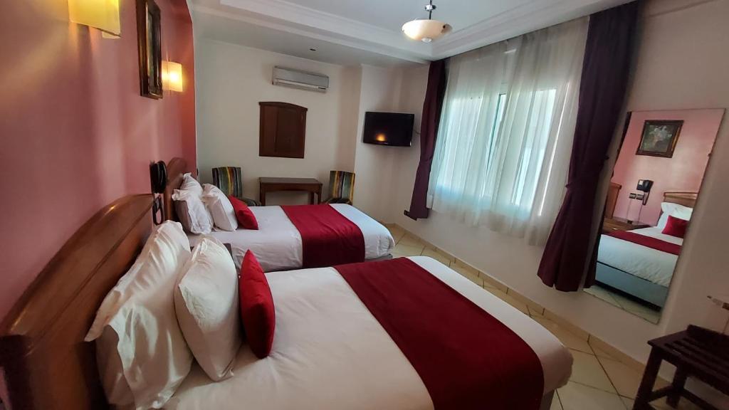 Postel nebo postele na pokoji v ubytování Hôtel Amouday