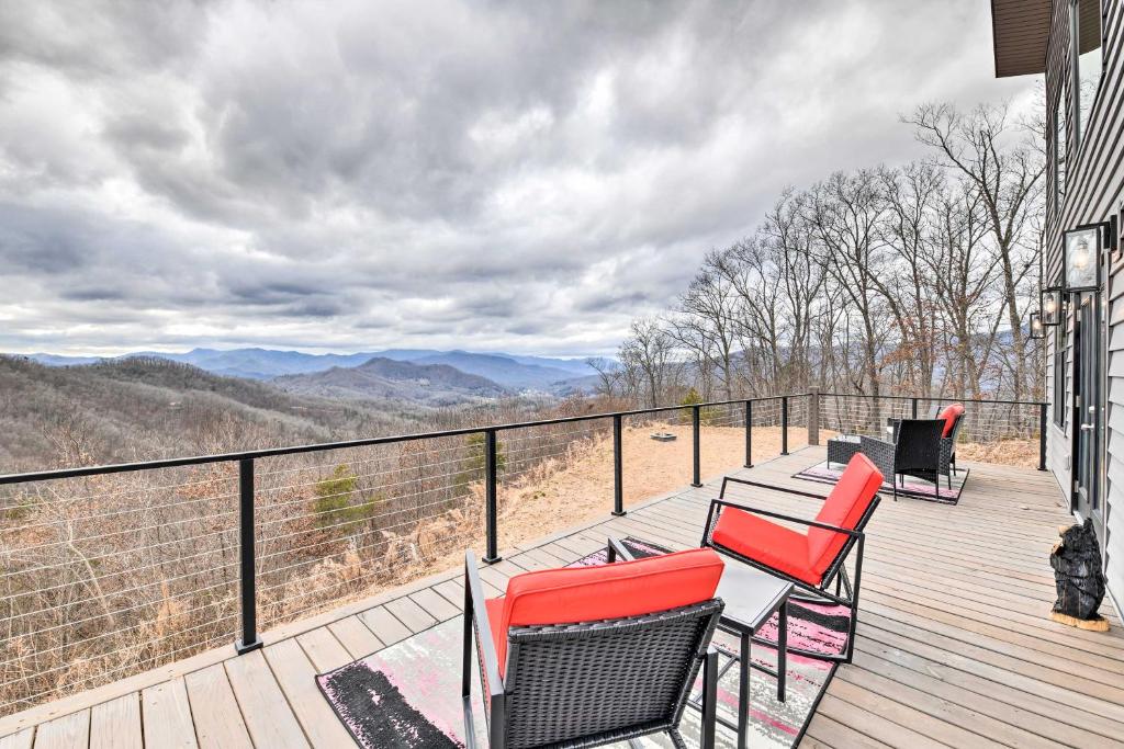 a balcony with chairs and a view of the mountains at Scenic Hillside Cabin in Sylva with Hot Tub and Views! in Sylva