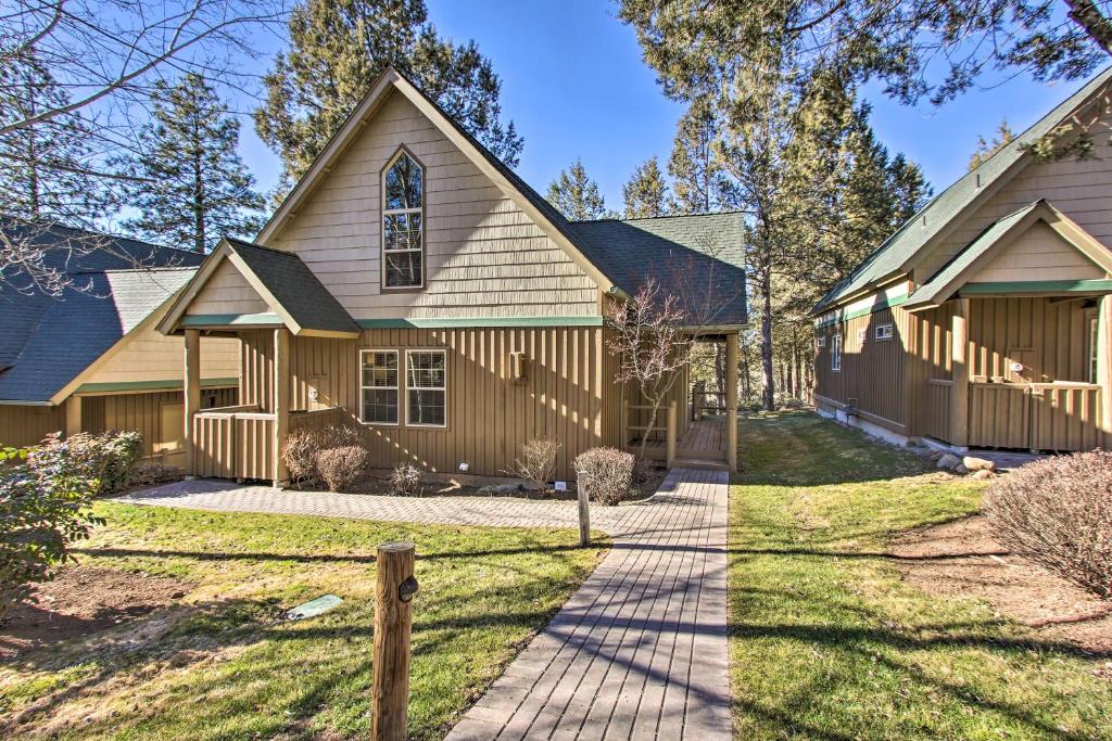 a house with a driveway and a church at Klamath Falls Cabin Retreat with Deck and Grill! in Klamath Falls