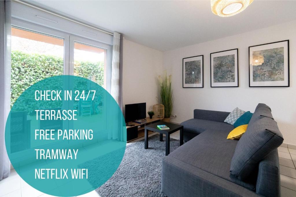 a living room with a couch and a tv at My Cozy Flat Blagnac - T2 - Free Parking - Terrasse - Jardin in Blagnac