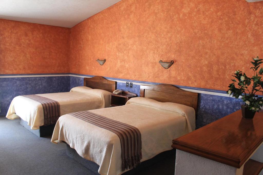 Postel nebo postele na pokoji v ubytování Hotel Meson del Puente