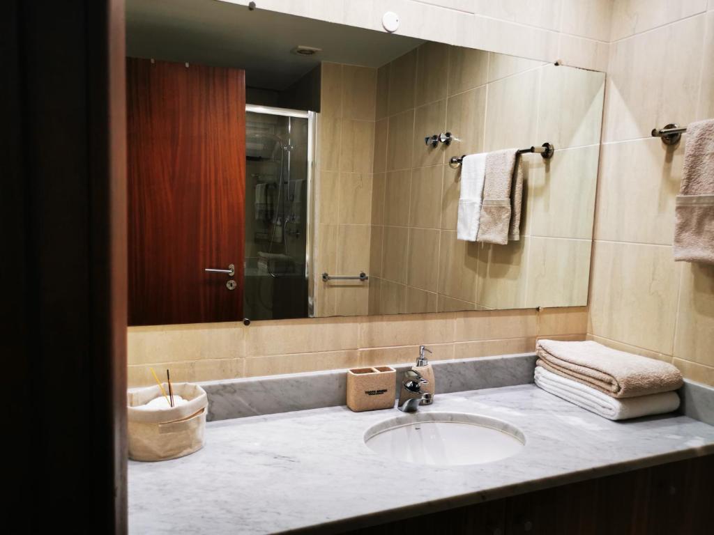 y baño con lavabo y espejo. en Apartamento com Vista para a Baía de Luanda en Luanda