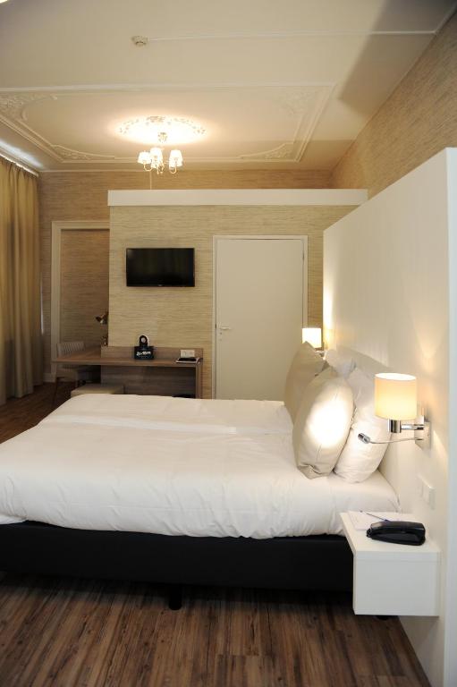 Postel nebo postele na pokoji v ubytování Hotel Andante aan Zee