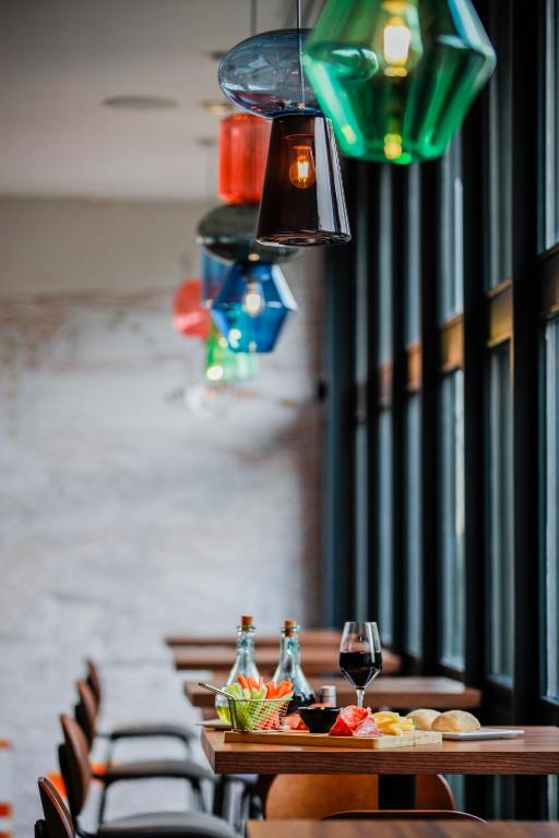 a row of tables with glasses of wine on them at Ibis Luxembourg Airport in Luxembourg