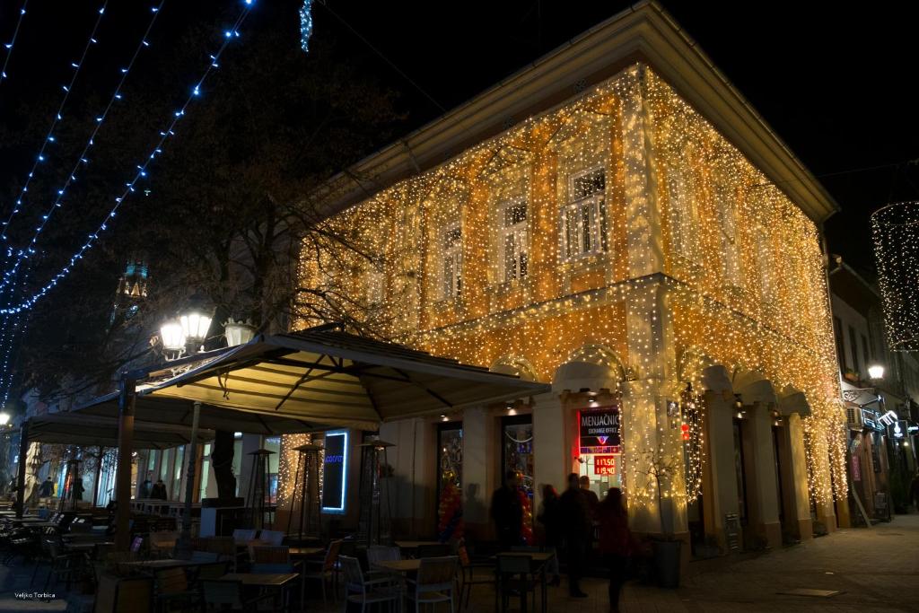 a building with christmas lights on the side of it at Corso Rooms City Centre in Novi Sad