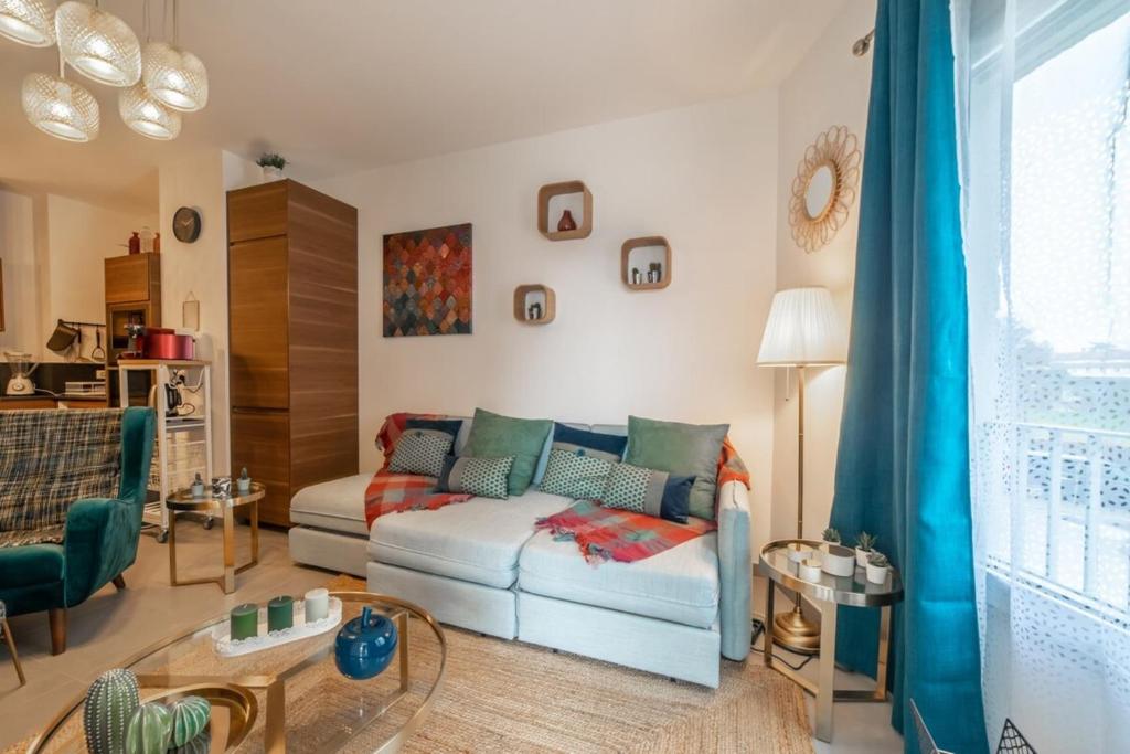 een woonkamer met een bank en een tafel bij Apartment with terrace and garage Classified 4 stars in Annecy