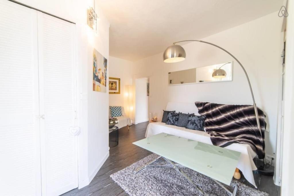 a living room with a couch and a table at Amélia Appartement Saint-Jorioz in Saint-Jorioz