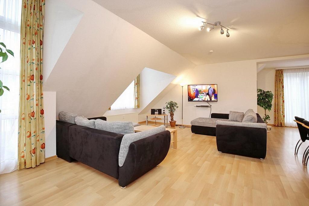 a living room with two couches and a tv at Sünnslag Wohnung 148 in Boltenhagen