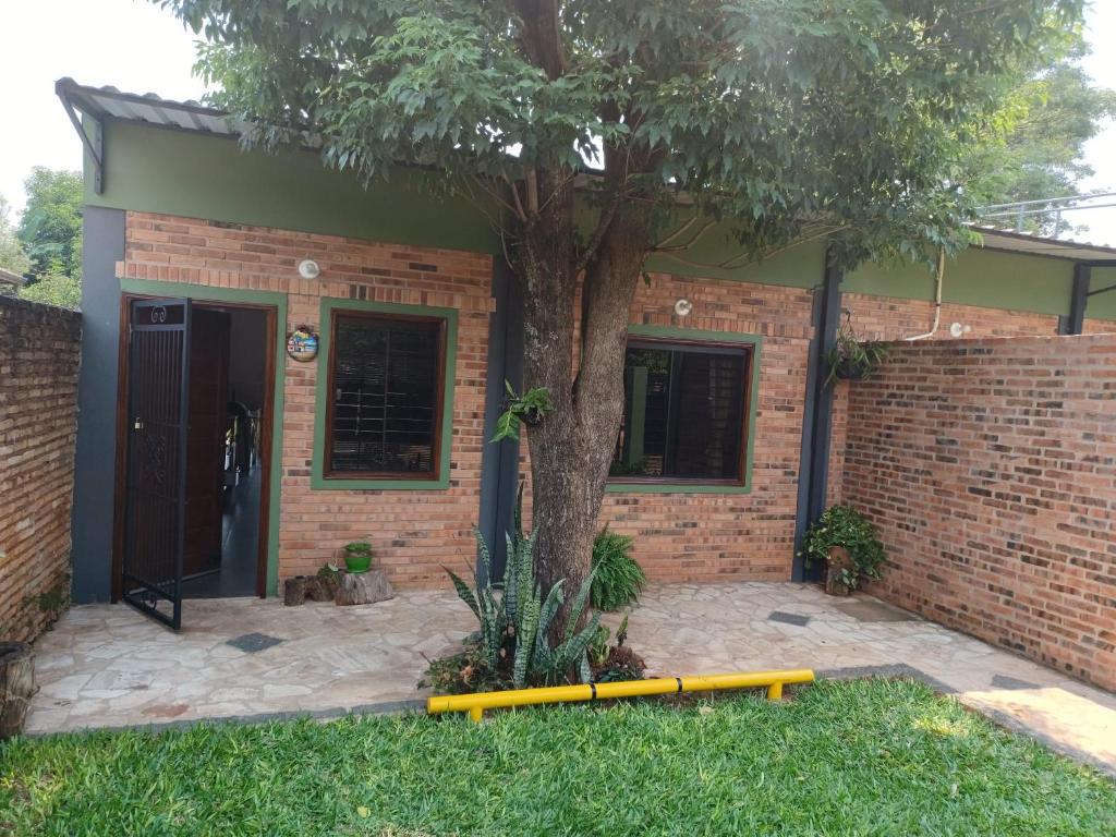 a house with a tree in front of it at Casa Naranja in San Lorenzo