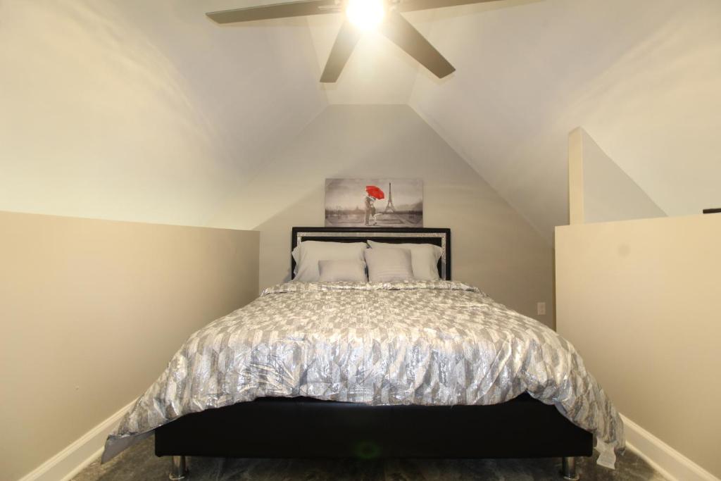 a bedroom with a bed with a ceiling fan at Modern Tiny House Experience in Stone Mountain