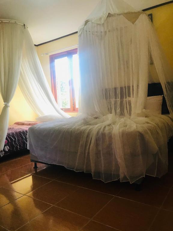 Postel nebo postele na pokoji v ubytování Sugi Gede Homestay