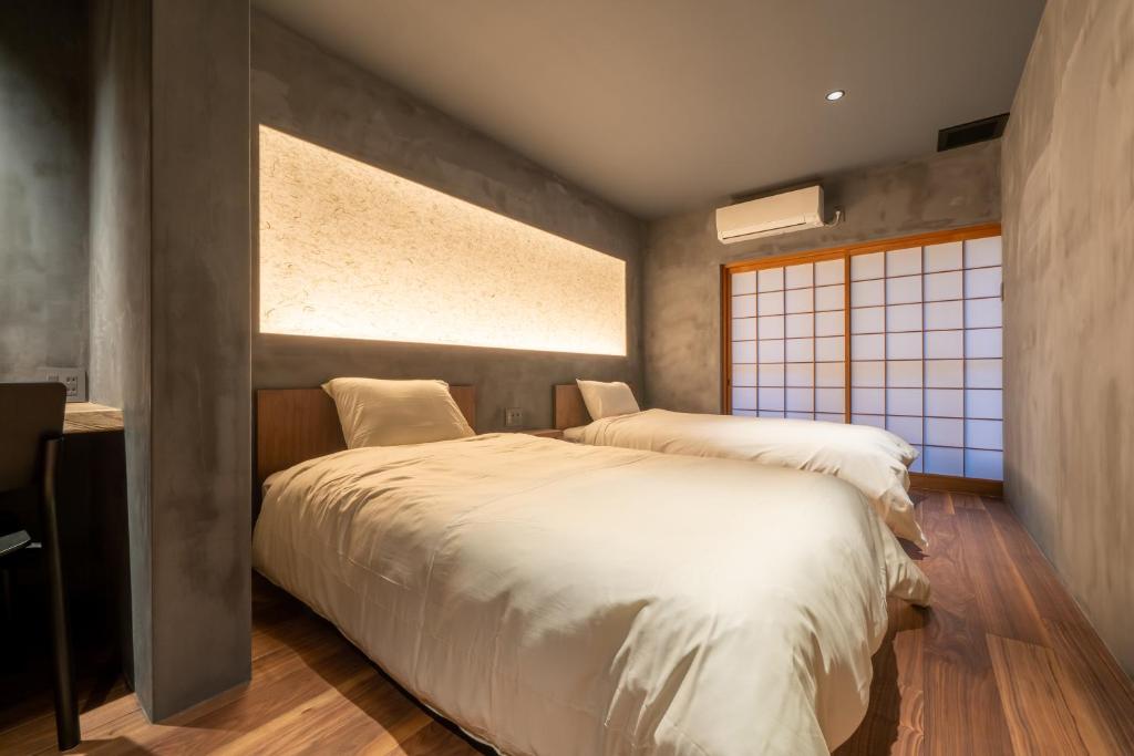 Postel nebo postele na pokoji v ubytování Ryokan Yamazaki