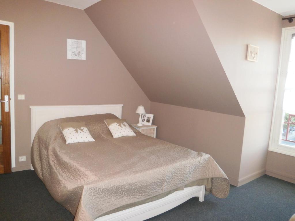 a bedroom with a bed in a attic at Aux Fontaines Honfleur in Honfleur