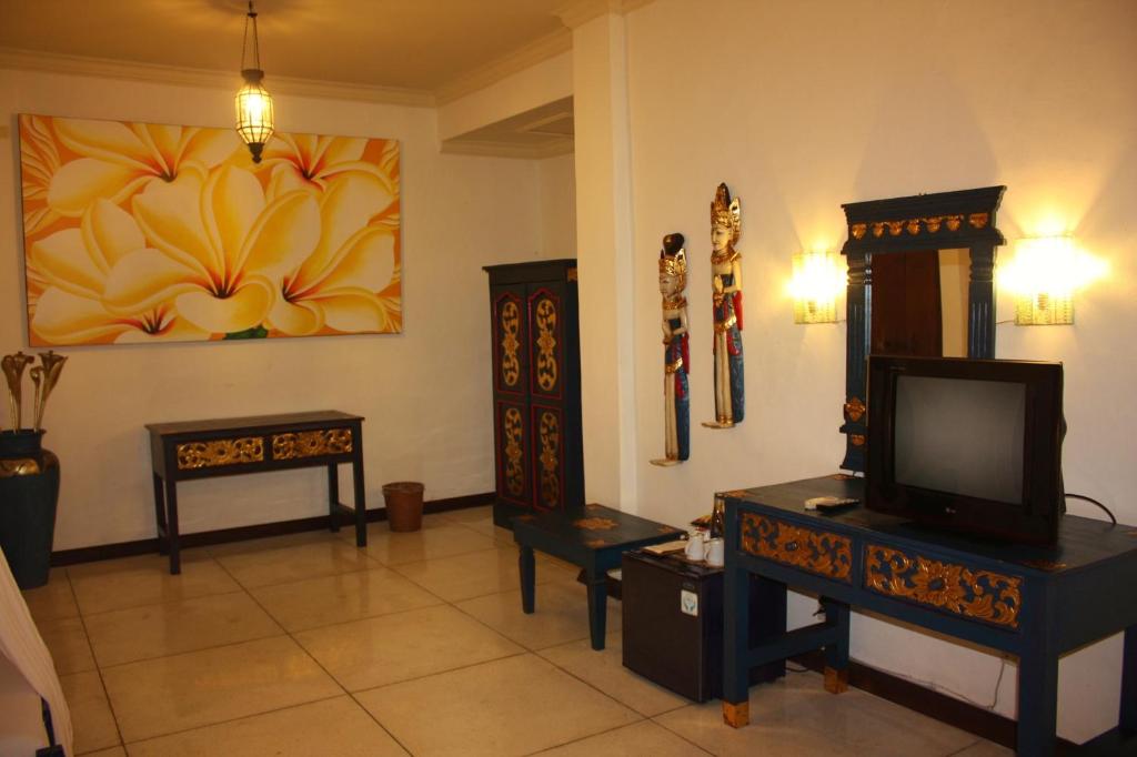 TV a/nebo společenská místnost v ubytování Puri Cendana Resort Bali
