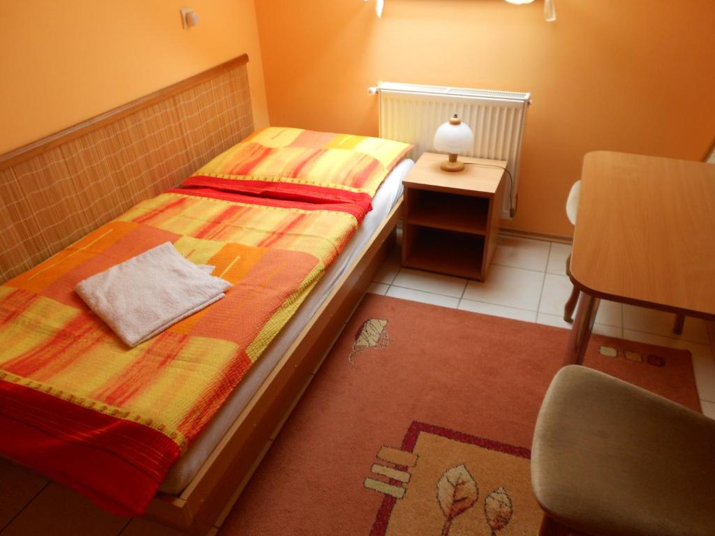 A bed or beds in a room at Penzion Rosnicka Liesek