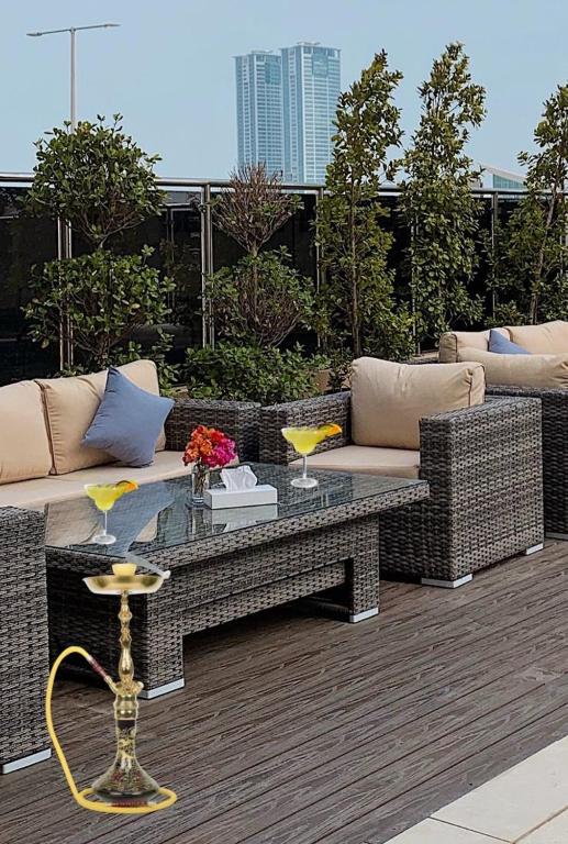 a patio with couches and a table on a deck at Royal View Hotel in Ras al Khaimah