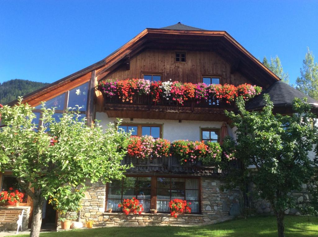 a house with flower boxes on the side of it at Ferienwohnungen Schartner in Mauterndorf