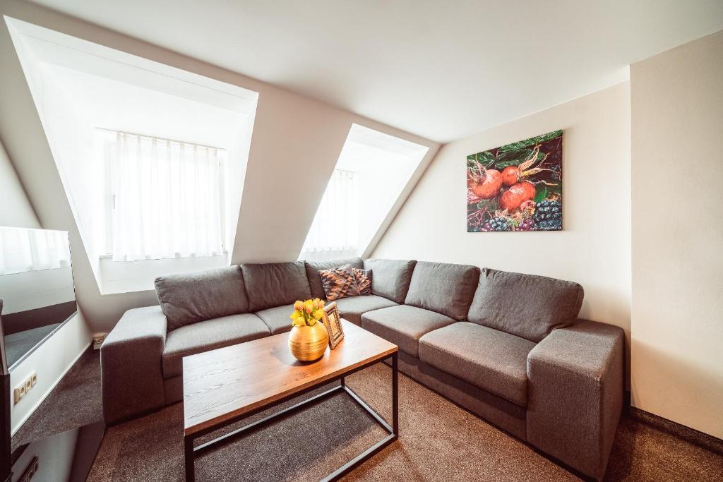 a living room with a couch and a table at Familienapartment Am Neumarkt lll in Dresden