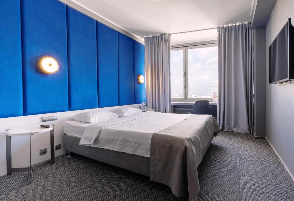 Кровать или кровати в номере Отель Аструс Москва