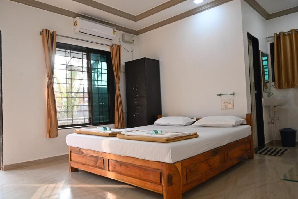 a bedroom with a large bed in a room at Hotel Chivla Paradise in Malvan