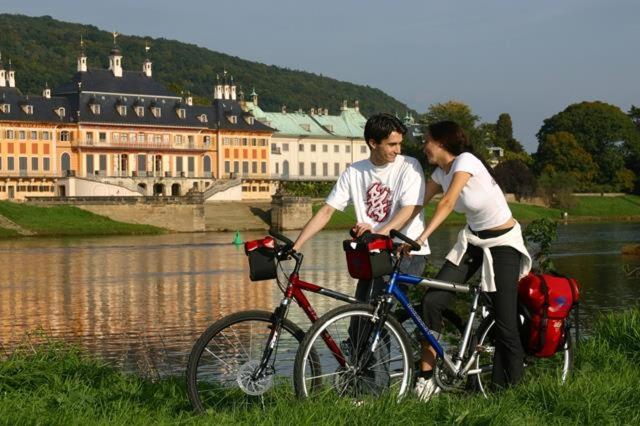a man and a woman standing next to a bike at Z Testhotel Zur Sonne in Dresden