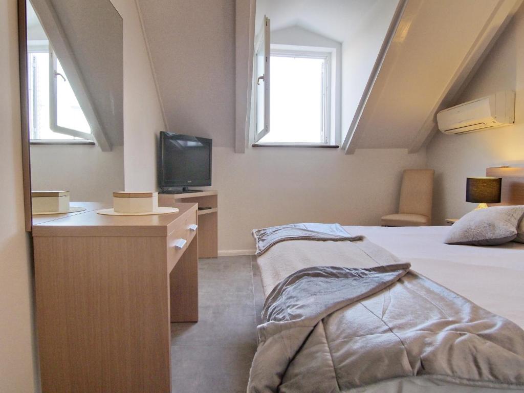 Postel nebo postele na pokoji v ubytování Apartment & Rooms Ivušić