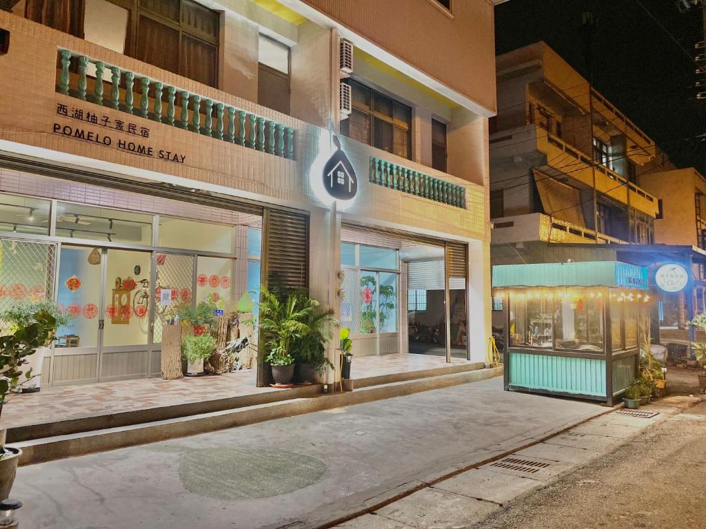 a store front of a building at night at 西湖柚子家民宿 in Xihu