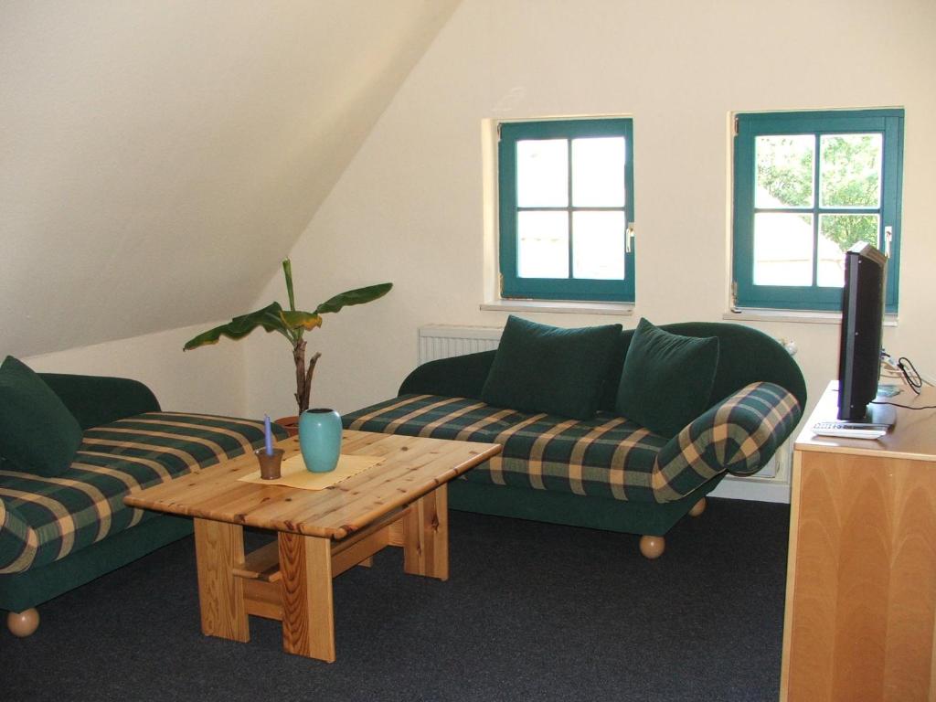 a living room with two couches and a coffee table at Ferienwohnung B Gästehaus Mühlenstein in Bad Sülze