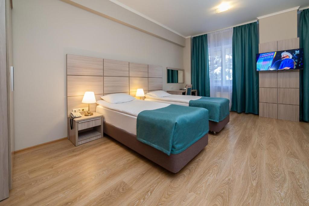 En eller flere senge i et værelse på Парк-отель Медвежьи Озера
