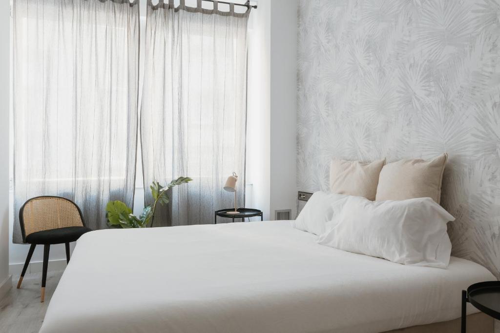 A bed or beds in a room at Apartamentos Espai Progres by Be Barcelona