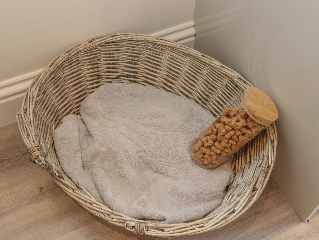 a wicker basket with a wooden spoon and food in it at Mews House in Camborne