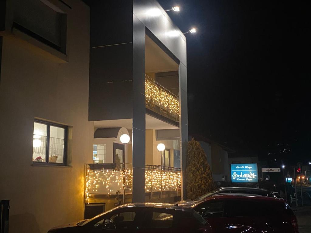 a car parked in front of a building at night at B&B Maya in Merano