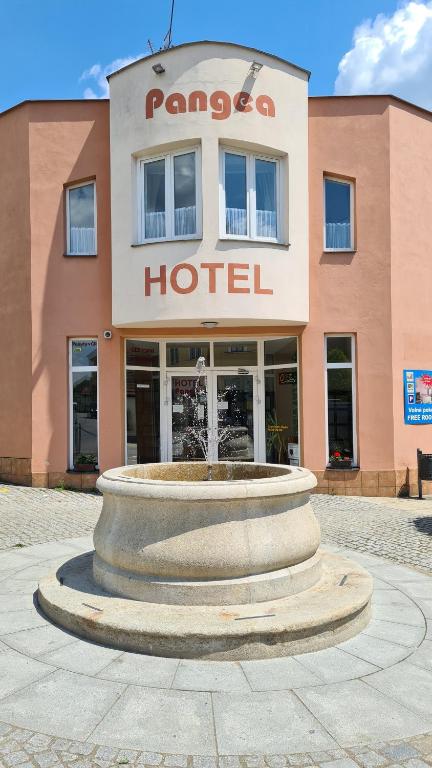 a large building with a clock on the front of it at Hotel Pangea in Telč