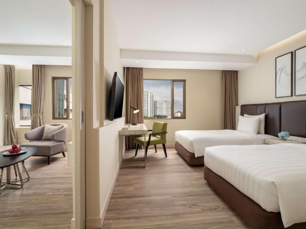 Postel nebo postele na pokoji v ubytování AIHO Hotel Medan