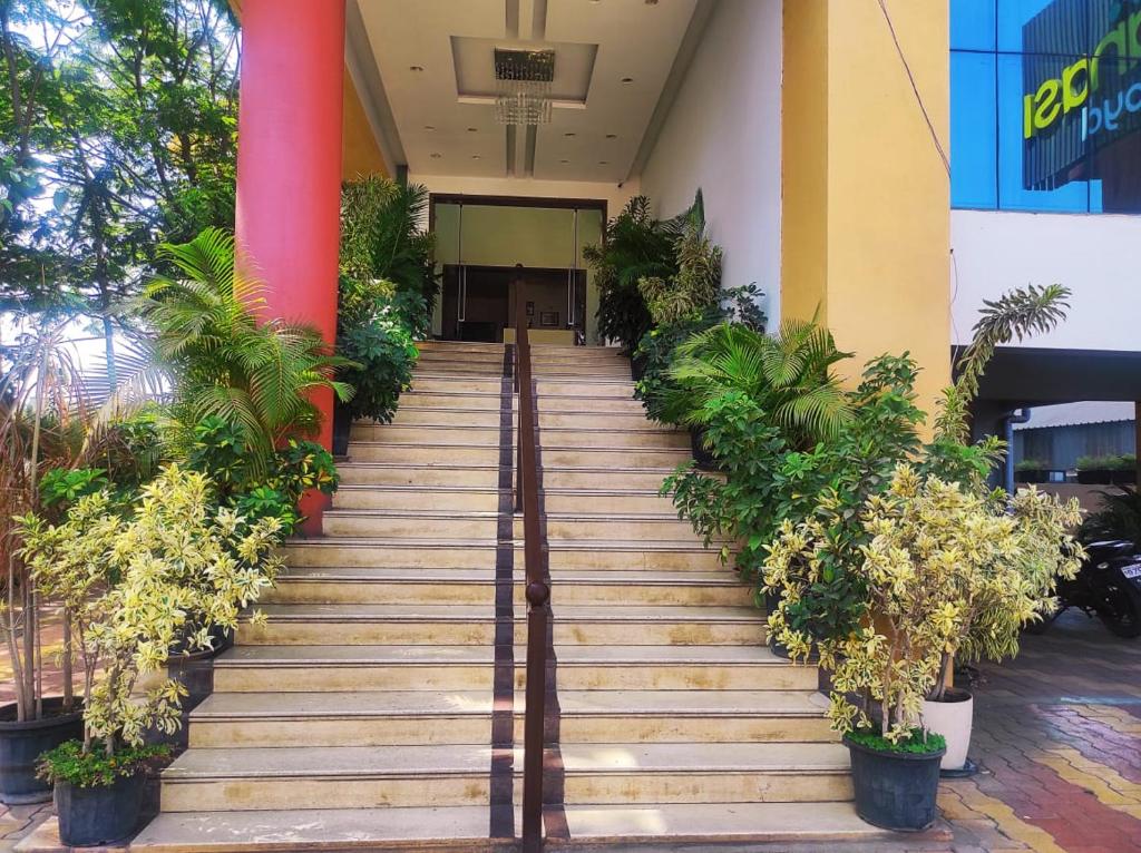 a set of stairs in front of a building at Hotel Manasi Royal in Satara