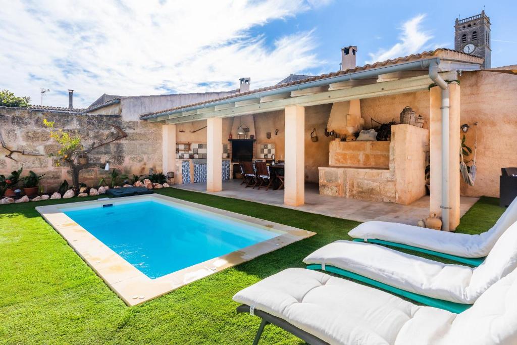 ein Hinterhof mit einem Swimmingpool und einem Haus in der Unterkunft Cas Padri Teco in Ariany