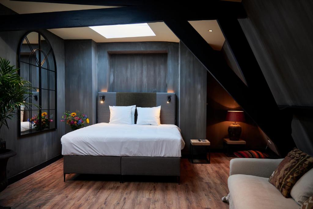 a bedroom with a large bed and a large window at City Center Lodge Utrecht in Utrecht