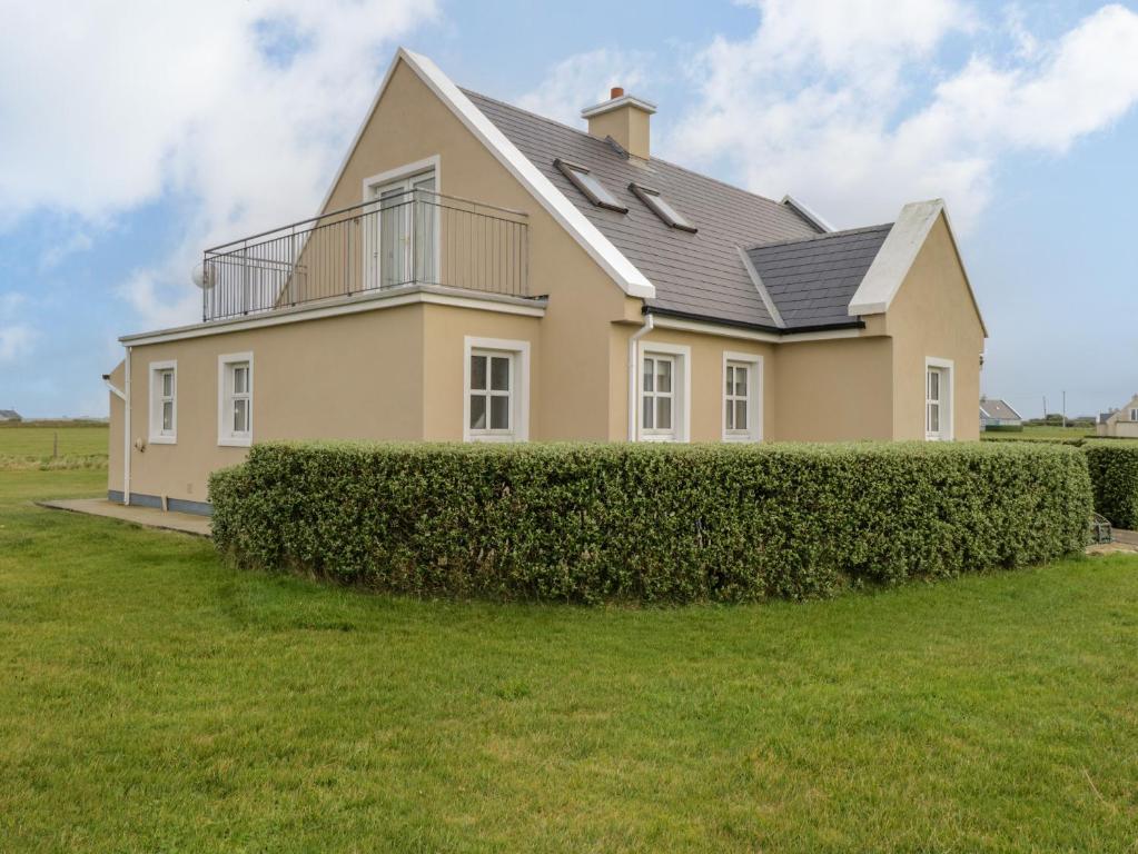 a large house with a hedge in front of it at 8 Lios Na Sioga in Belmullet